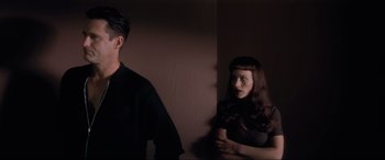 Movie still from “Lost Highway” (1997), directed by David Lynch – A man and a woman standing next to each other in a room; Medium shot, Low angle