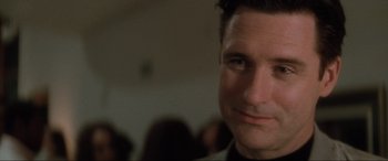 Movie still from “Lost Highway” (1997), directed by David Lynch – A man's face in front of a group of people; Close Up shot, Low angle