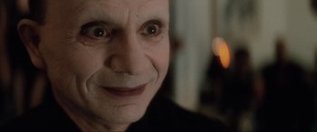 Movie still from “Lost Highway” (1997), directed by David Lynch – An old man with a creepy smile on his face; Extreme Close Up shot, High angle