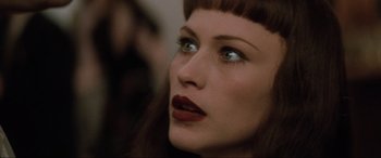 Movie still from “Lost Highway” (1997), directed by David Lynch – A person wearing a red lipstick; Close Up shot, Over the shoulder angle
