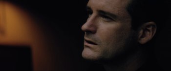 Movie still from “Lost Highway” (1997), directed by David Lynch – A man's face in the dark; Close Up shot, Low angle