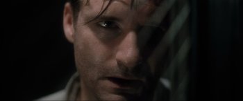 Movie still from “Lost Highway” (1997), directed by David Lynch – A man's face in a dark room; Extreme Close Up shot, Over the shoulder angle