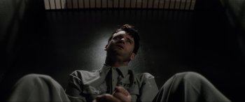 Movie still from “Lost Highway” (1997), directed by David Lynch – A man sitting in a chair looking up at the ceiling; Close Up shot, Low angle