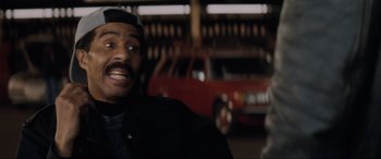 Movie still from “Lost Highway” (1997), directed by David Lynch – A person with a car in the background; Close Up shot, Over the shoulder angle