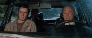 Movie still from “Lost Highway” (1997), directed by David Lynch – Two men sitting in the back seat of a car; Medium shot, Over the shoulder angle