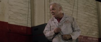 Movie still from “Lost Highway” (1997), directed by David Lynch – An older man holding a pair of scissors in his hand; Medium shot, Low angle