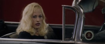 Movie still from “Lost Highway” (1997), directed by David Lynch – A woman sitting in the back seat of a classic car; Close Up shot, Over the shoulder angle