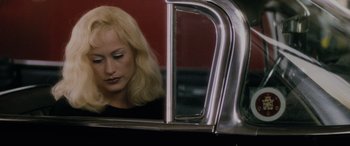 Movie still from “Lost Highway” (1997), directed by David Lynch – A woman sitting in the passenger seat of a car looking out the window; Close Up shot, Over the shoulder angle