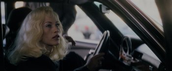 Movie still from “Lost Highway” (1997), directed by David Lynch – A woman sitting in the driver's seat of a car; Close Up shot, Over the shoulder angle