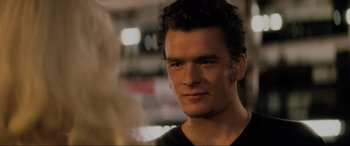 Movie still from “Lost Highway” (1997), directed by David Lynch – A person wearing a black t - shirt; Close Up shot, Over the shoulder angle