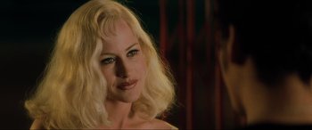 Movie still from “Lost Highway” (1997), directed by David Lynch – A woman with blonde hair is smiling for the camera; Close Up shot, Over the shoulder angle