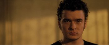 Movie still from “Lost Highway” (1997), directed by David Lynch – A man's face in a black shirt; Close Up shot, Low angle