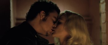 Movie still from “Lost Highway” (1997), directed by David Lynch – A man and a woman kissing each other; Close Up shot, Overhead angle