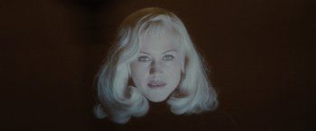 Movie still from “Lost Highway” (1997), directed by David Lynch – A woman with blonde hair is looking at the camera; Close Up shot, Low angle