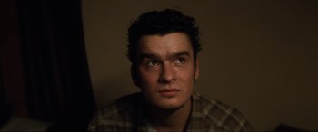 Movie still from “Lost Highway” (1997), directed by David Lynch – A person looking at the camera; Close Up shot, High angle