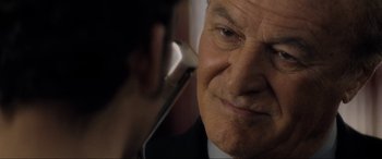 Movie still from “Lost Highway” (1997), directed by David Lynch – An older man is talking on a cell phone; Close Up shot, Over the shoulder angle