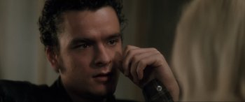 Movie still from “Lost Highway” (1997), directed by David Lynch – A person holding a cell phone to his ear; Close Up shot, Over the shoulder angle