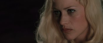 Movie still from “Lost Highway” (1997), directed by David Lynch – A person with blonde hair; Close Up shot, Over the shoulder angle