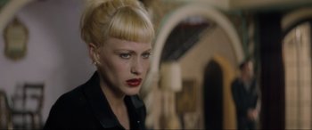 Movie still from “Lost Highway” (1997), directed by David Lynch – A woman with blonde hair and red lipstick looking to her left; Close Up shot, Over the shoulder angle