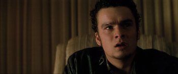 Movie still from “Lost Highway” (1997), directed by David Lynch – A person wearing a leather jacket; Close Up shot, High angle