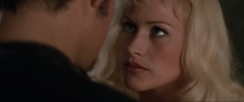 Movie still from “Lost Highway” (1997), directed by David Lynch – A man and a woman looking at each other in front of a mirror; Close Up shot, Over the shoulder angle