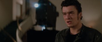 Movie still from “Lost Highway” (1997), directed by David Lynch – A young man is crying in front of a camera; Close Up shot, Over the shoulder angle