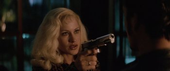Movie still from “Lost Highway” (1997), directed by David Lynch – A woman with blonde hair holding a gun in her hand; Close Up shot, Over the shoulder angle