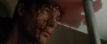 Movie still from “Lost Highway” (1997), directed by David Lynch – A person with blood on his face; Extreme Close Up shot, High angle