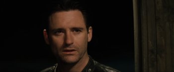 Movie still from “Lost Highway” (1997), directed by David Lynch – A person wearing a leather jacket; Close Up shot, Over the shoulder angle