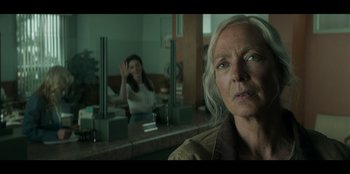 Movie still from “Lou” (2022), directed by Anna Foerster – An older woman looking at a younger woman in the mirror; Medium shot, Over the shoulder angle