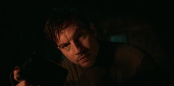 Movie still from “Lou” (2022), directed by Anna Foerster – A person in a dark room; Close Up shot, Low angle