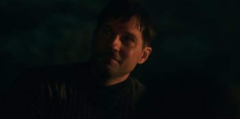 Movie still from “Lou” (2022), directed by Anna Foerster – A person in a dark room; Close Up shot, Over the shoulder angle