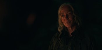 Movie still from “Lou” (2022), directed by Anna Foerster – A woman with long blonde curly hair wearing a black jacket; Close Up shot, Over the shoulder angle