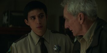 Movie still from “Lou” (2022), directed by Anna Foerster – A man in a uniform talking to another man in a uniform; Close Up shot, Over the shoulder angle