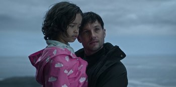 Movie still from “Lou” (2022), directed by Anna Foerster – A man and a little girl standing next to each other; Close Up shot, Low angle