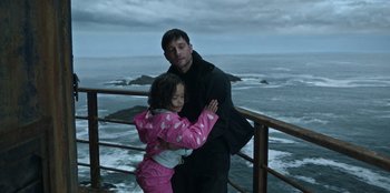 Movie still from “Lou” (2022), directed by Anna Foerster – A man and a little girl standing next to a railing; Medium shot, Low angle