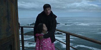 Movie still from “Lou” (2022), directed by Anna Foerster – A man and a little girl standing next to a railing; Medium shot, Low angle