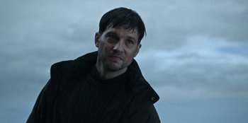 Movie still from “Lou” (2022), directed by Anna Foerster – A person wearing a jacket; Close Up shot, Low angle