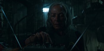 Movie still from “Lou” (2022), directed by Anna Foerster – An older woman is playing a game on a keyboard; Close Up shot, Low angle