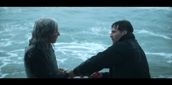 Movie still from “Lou” (2022), directed by Anna Foerster – A man and a woman holding hands near a body of water; Medium shot, Over the shoulder angle