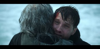 Movie still from “Lou” (2022), directed by Anna Foerster – A man with his head in his face; Close Up shot, Over the shoulder angle