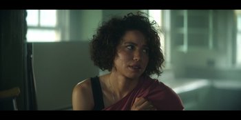 Movie still from “Lou” (2022), directed by Anna Foerster – A person wearing a red shirt; Close Up shot, Over the shoulder angle