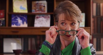 Movie still from “Love Again” (2023), directed by Jim Strouse – A woman holding a pair of glasses in her hands; Close Up shot, Over the shoulder angle