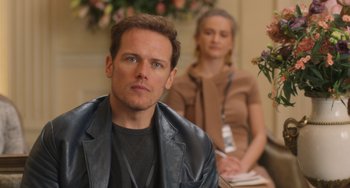 Movie still from “Love Again” (2023), directed by Jim Strouse – A man and a woman sitting in front of each other; Close Up shot, Over the shoulder angle