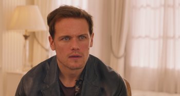 Movie still from “Love Again” (2023), directed by Jim Strouse – A person wearing a leather jacket; Close Up shot, Over the shoulder angle