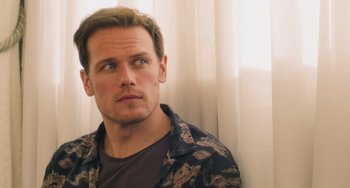 Movie still from “Love Again” (2023), directed by Jim Strouse – A person wearing a shirt; Close Up shot, Over the shoulder angle