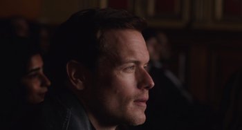 Movie still from “Love Again” (2023), directed by Jim Strouse – A person looking to his left; Extreme Close Up shot, Over the shoulder angle