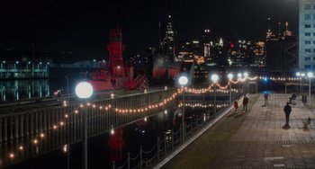 Movie still from “Love Again” (2023), directed by Jim Strouse – A view of a city lit up at night; Extreme Wide shot, High angle