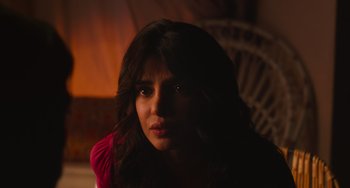 Movie still from “Love Again” (2023), directed by Jim Strouse – A person sitting in a room; Close Up shot, Over the shoulder angle