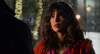 Movie still from “Love Again” (2023), directed by Jim Strouse – A person with long hair; Close Up shot, Over the shoulder angle